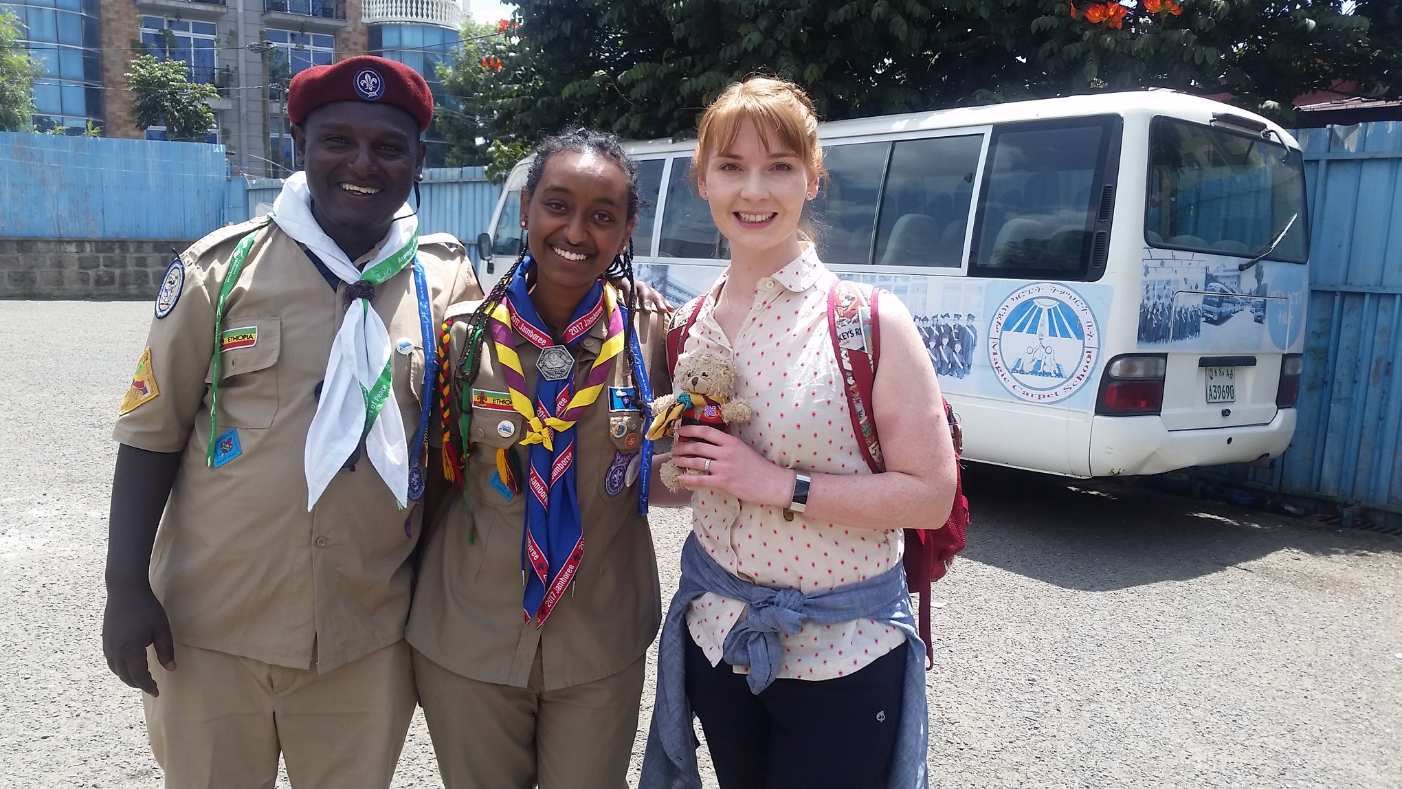 Saron Gebre in her scout uniform, standing alongside two other scouts from Ethiopia and Scotland.
